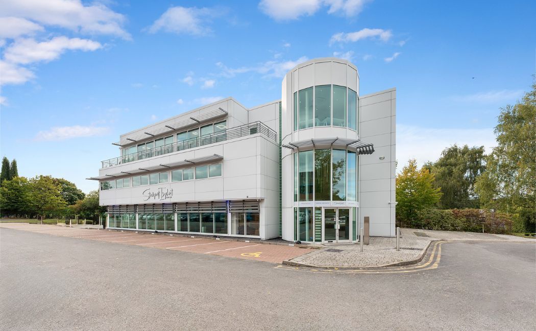 Century House on Pepper Road, Hazel Grove: a modern white building with the clinic's signage and parking bays in front.