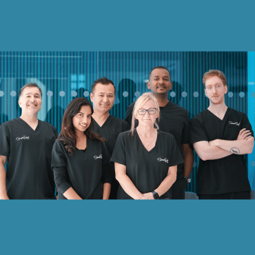 The clinic's dental laboratory team in matching black uniforms.